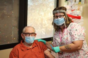 Nurse Roxy Carlson, RN administers the Moderna COVID-19 vaccine to WWII Marine Corps Veteran Edwin “Corky” Davis at the Northern Arizona VA's Community Living Center. Courtesy Northern Arizona VA Health Care System