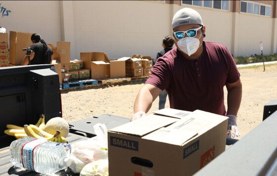 Cody Honani with the Hopi Foundation Emergency Relief team loads a truck with food and PPE resources at a distribution that was held in Kykotsmovi.