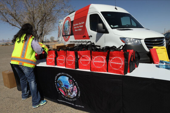 A Relief Fund volunteer sets up adult PPE kits to be dispersed at a PPE distribution event held at City Market in Shiprock, N.M.
