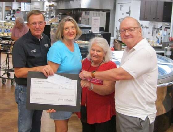 Clark’s Market Dave Miller Store Director, Museum President Janeen Trevillyan, and Museum volunteers Jan Oswald and Bill Levengood met at the store to accept the donation