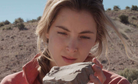 A rock climbing geology student travels to the Nevada high desert to do research, where a career-defining fossil discovery and an unexpected friendship with a young cattle rancher force her to reevaluate her path in “Unconformity”.