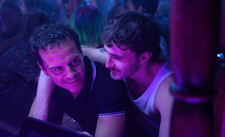 One night in his near-empty tower block in contemporary London, Adam (Andrew Scott) has a chance encounter with a mysterious neighbor Harry (Paul Mescal), which punctures the rhythm of his everyday life in “All of Us Strangers”.