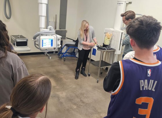 Getting Their Hands on the Future Radiology Program Director Tracy Rogers (center) demonstrates medical imaging equipment to middle school students
