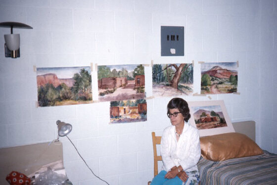 Helen Jordan surrounded by some of her paintings
