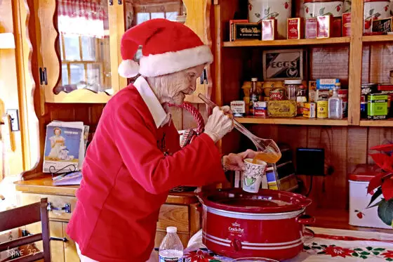 Museum volunteer Ann Pearson serves up spiced apple cider. Photo courtesy of Larry Kane.